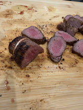 Lamb Tenderloin prepared on a wooden cutting board